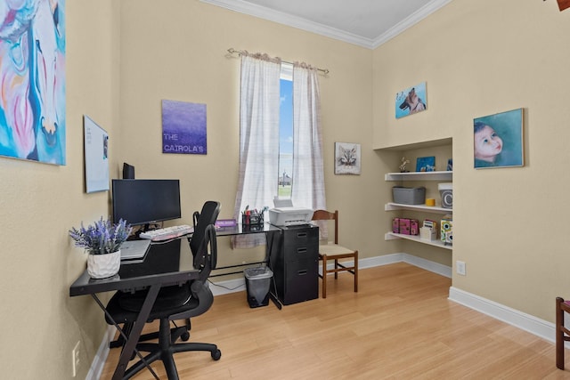 home office featuring built in shelves, baseboards, ornamental molding, and wood finished floors