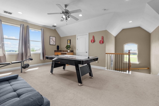 recreation room featuring light colored carpet, baseboards, a healthy amount of sunlight, and visible vents