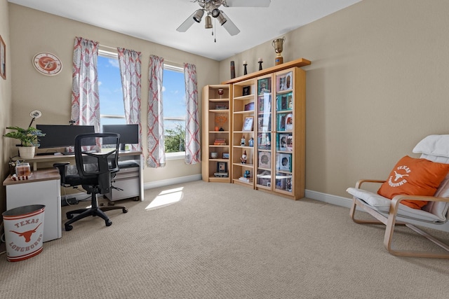 office featuring carpet, a ceiling fan, and baseboards