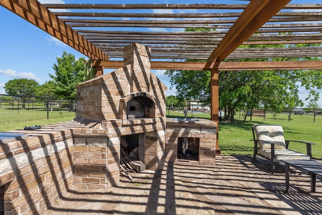 view of patio / terrace with a pergola, an outdoor fireplace, and fence