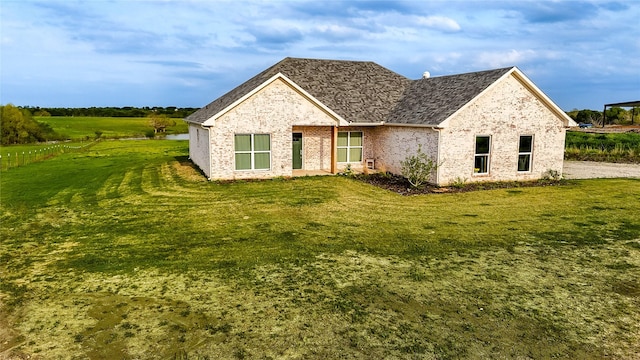 view of front of property featuring brick siding and a front yard
