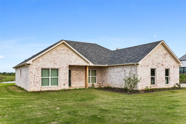 view of front of home with brick siding and a front yard