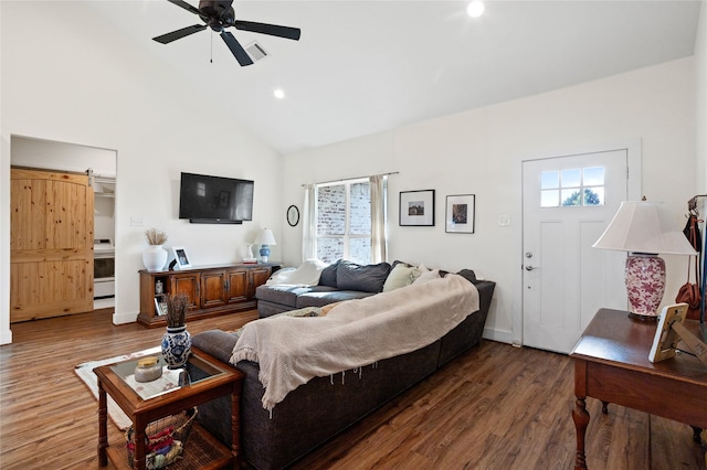 living area with wood finished floors, a healthy amount of sunlight, high vaulted ceiling, and ceiling fan