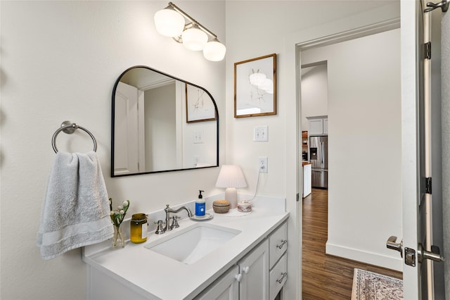 bathroom featuring wood finished floors and vanity