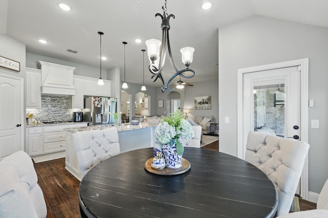 1057 Canterbury Ln, Forney, TX 75126 - dining room with dark wood-type flooring, a chandelier, recessed lighting, vaulted ceiling, and arched walkways