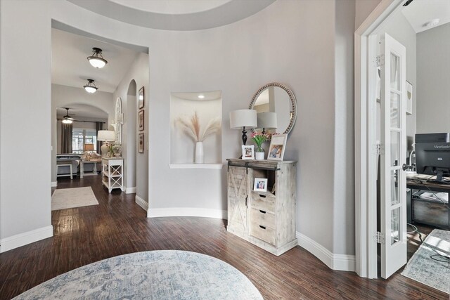 1057 Canterbury Ln, Forney, TX 75126 - foyer featuring wood finished floors, arched walkways, and baseboards