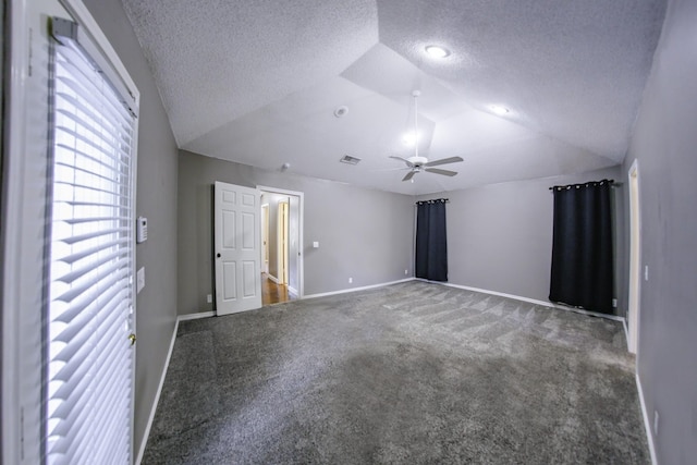 carpeted empty room featuring ceiling fan, a textured ceiling, baseboards, and lofted ceiling
