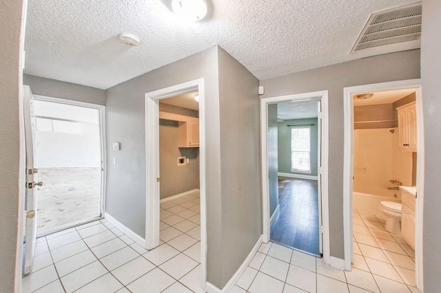 bathroom featuring tile patterned floors, visible vents, baseboards, and toilet