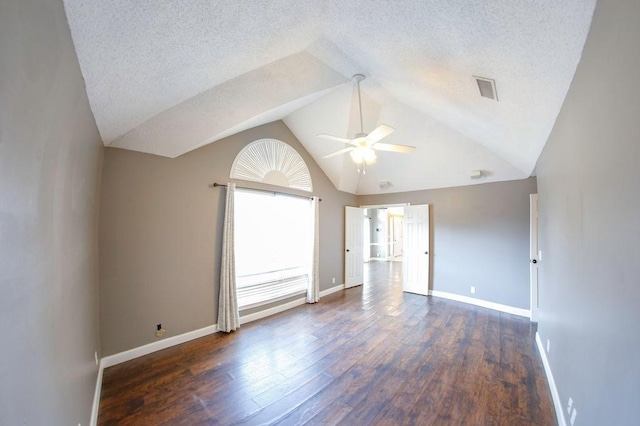 unfurnished room featuring ceiling fan, visible vents, wood finished floors, lofted ceiling, and baseboards