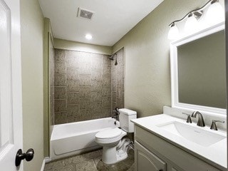 bathroom with toilet, shower / bath combination, vanity, and visible vents