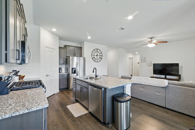 903 Saddle Club Way, Princeton, TX 75407 - kitchen featuring stainless steel appliances, open floor plan, ceiling fan, dark wood-style flooring, and backsplash