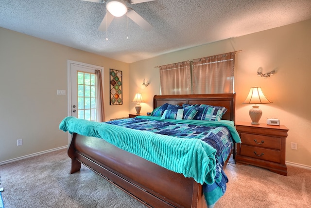 carpeted bedroom with baseboards, a ceiling fan, and a textured ceiling