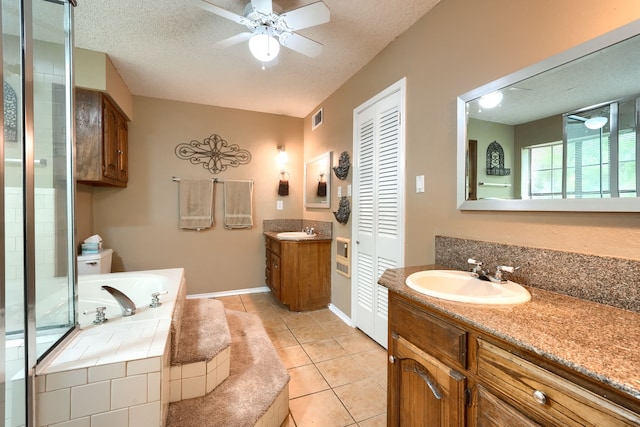 full bath with a bath, ceiling fan, a sink, and visible vents