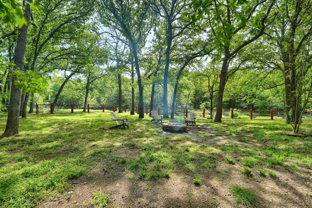view of yard with an outdoor fire pit and fence
