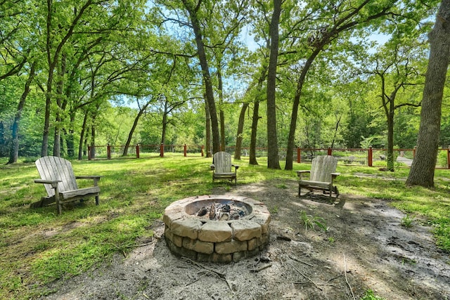 view of yard with fence and an outdoor fire pit