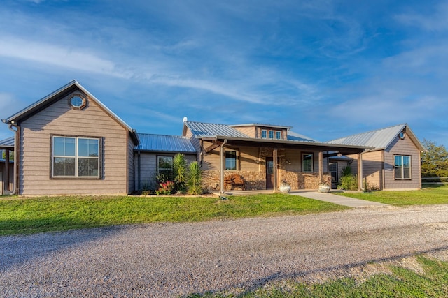 single story home featuring a front lawn and metal roof