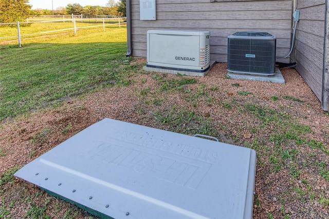 details featuring a power unit, central air condition unit, and fence