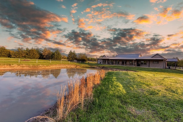 property view of water featuring fence