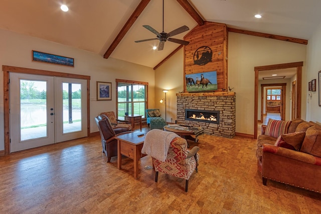 living room with french doors, beam ceiling, plenty of natural light, and a fireplace