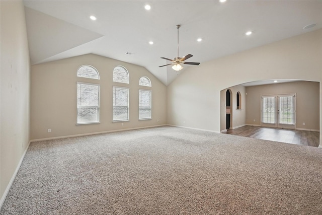 202 Lake Rdg, Princeton, TX 75407 - unfurnished living room with baseboards, carpet flooring, lofted ceiling, arched walkways, and ceiling fan