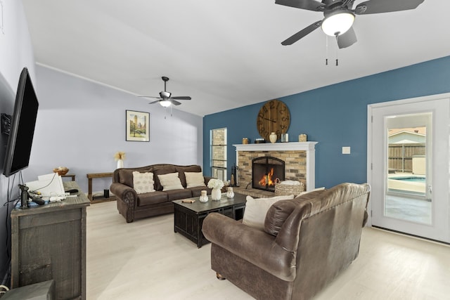 2113 Victoria Rd, Carrollton, TX 75007 - living area with a fireplace, vaulted ceiling, light wood-type flooring, and ceiling fan