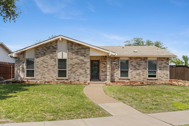 2113 Victoria Rd, Carrollton, TX 75007 - view of front of property featuring brick siding, a front lawn, and fence