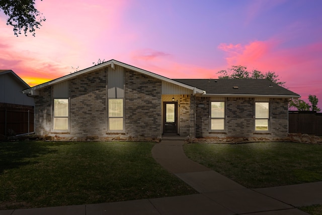 2113 Victoria Rd, Carrollton, TX 75007 - view of front facade featuring fence, brick siding, and a front yard