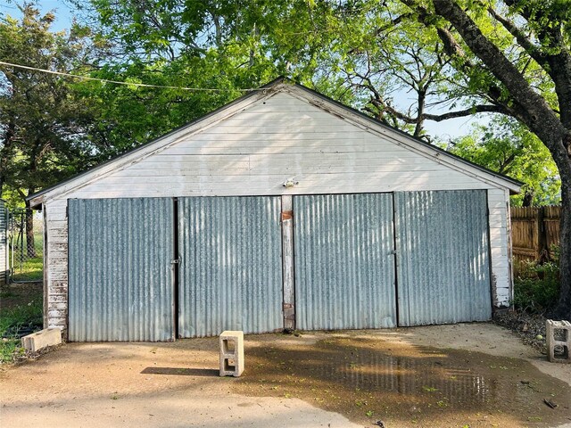 view of outbuilding with fence and an outdoor structure