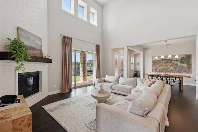 1304 S Pecan Pkwy, Northlake, TX 76247 - living room with a healthy amount of sunlight, dark wood finished floors, a chandelier, and a towering ceiling