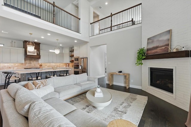 1304 S Pecan Pkwy, Northlake, TX 76247 - living room with a healthy amount of sunlight, dark wood finished floors, a chandelier, and a towering ceiling