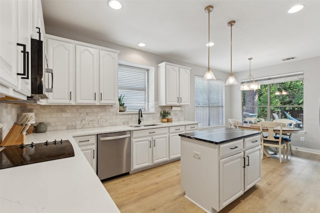 kitchen with stainless steel appliances, visible vents, a sink, and light wood-type flooring