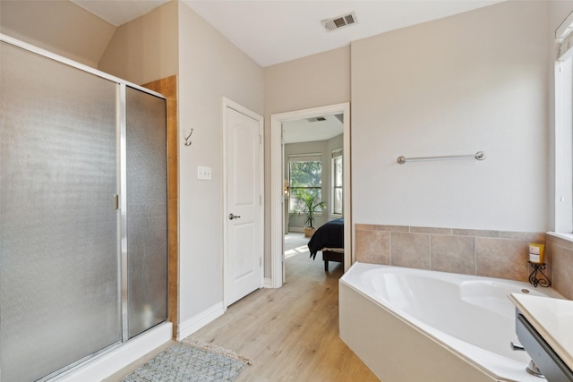 full bathroom featuring a garden tub, visible vents, a stall shower, wood finished floors, and ensuite bathroom