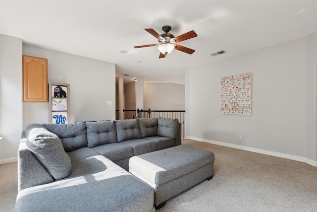 carpeted living area with baseboards, a ceiling fan, and visible vents