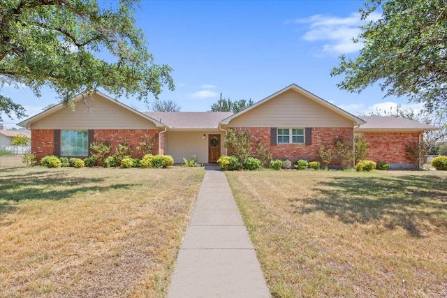 single story home with brick siding and a front lawn