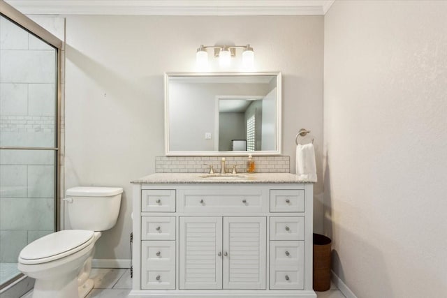 bathroom with baseboards, toilet, vanity, backsplash, and a stall shower