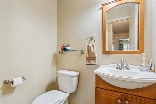 half bath featuring toilet and vanity