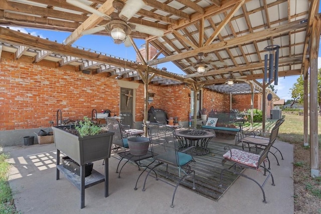 view of patio with outdoor dining area, central AC, and area for grilling