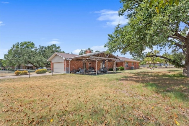 exterior space featuring a front yard, a garage, a chimney, fence, and brick siding