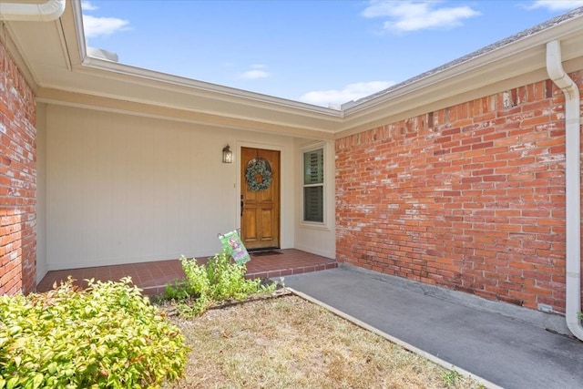property entrance with brick siding
