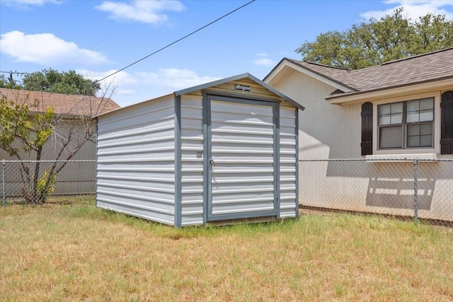 view of shed featuring fence