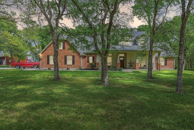 view of front of property with brick siding and a front lawn