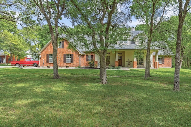 view of front of house featuring a front yard and brick siding