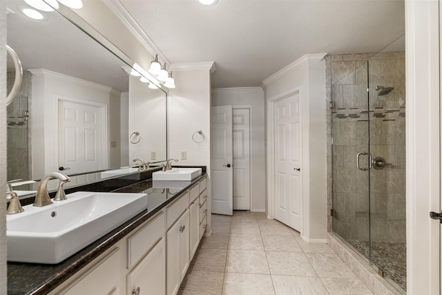 full bathroom with a sink, ornamental molding, and a shower stall