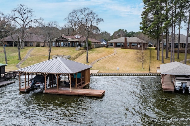 view of dock with a water view, a yard, and boat lift