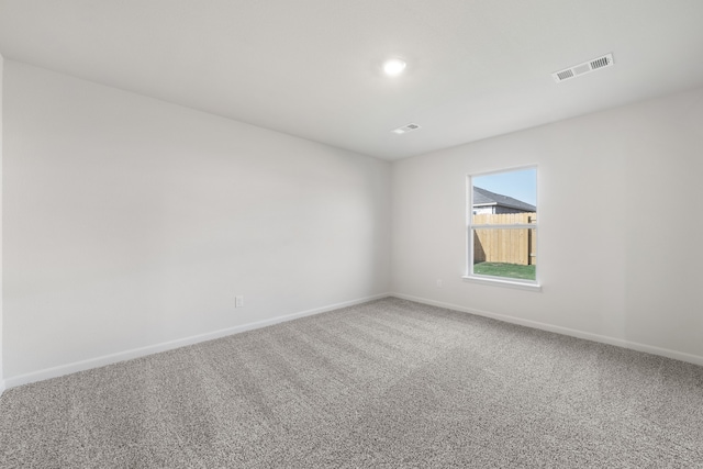empty room with carpet floors, baseboards, and recessed lighting