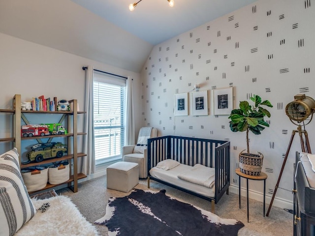 bedroom featuring light colored carpet, baseboards, and vaulted ceiling