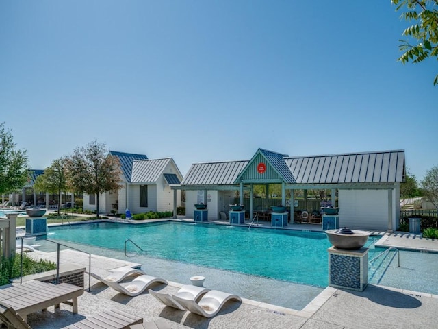 pool featuring a gazebo, a patio, and area for grilling