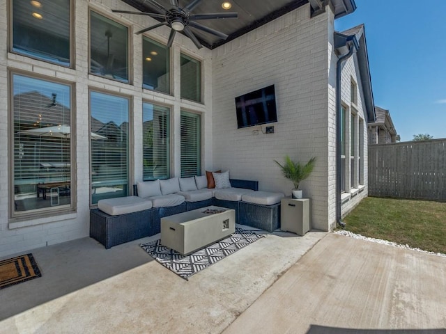 view of patio featuring fence, outdoor lounge area, and a ceiling fan