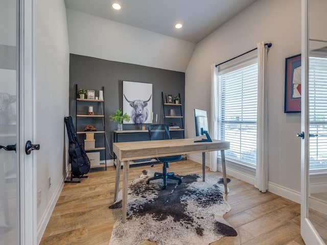 office area featuring light wood-style flooring, recessed lighting, vaulted ceiling, and baseboards