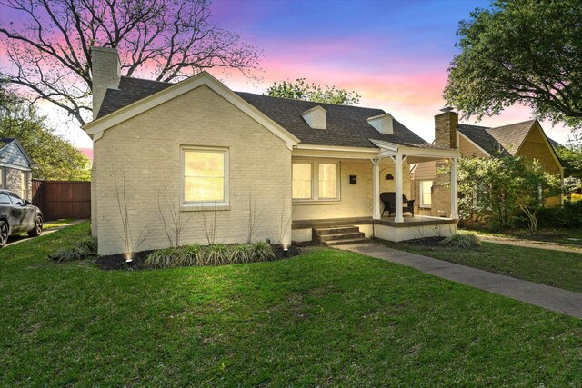 1622 Hollywood Ave, Dallas, TX 75208 - view of front of house with a chimney, covered porch, a yard, and brick siding
